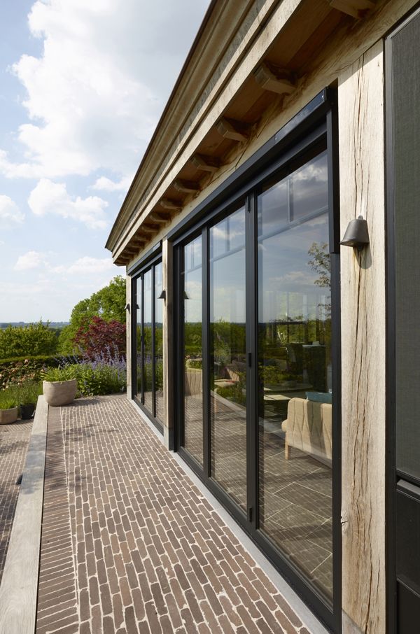 Eiken aanbouw orangerie met plat dak